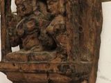 a wooden sculpture on the wall of a building