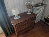une chambre avec un lit et une commode