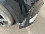 a close up of a black car with a broken door handle