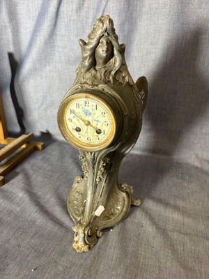 a clock that is sitting on a table next to a picture frame