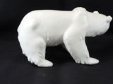 a white bear figurine on a black background