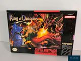 the box for the game king of dragons is sitting on a table