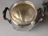 silver plated tea pot and teapot on a grey background