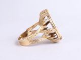 a close up of a gold ring on a white surface
