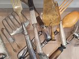 many different types of kitchen utensils hanging from the wall