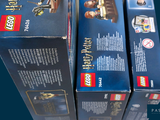 three boxes of legos that are stacked on top of each other