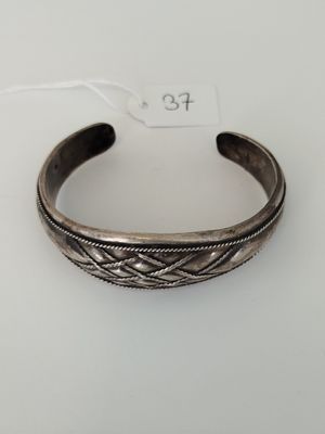 a silver bracelet with a braid design on it