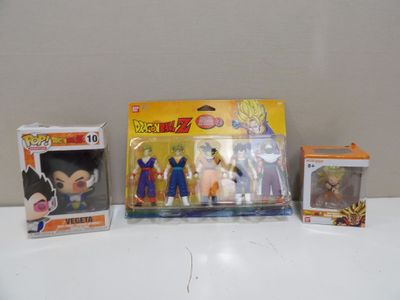 a box of dragon ball figures and a box of action figures on a table