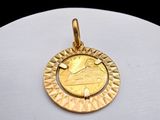 a close up of a gold coin on a white surface