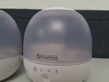 two white and gray humiders sitting on a table