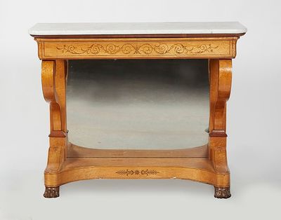 Console en bois clair reposant sur deux pieds griffes, décor…