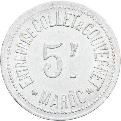 a close up of a coin with the number 5 on it