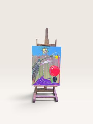 un petit chevalet sur lequel est posé un tableau représentant un oiseau