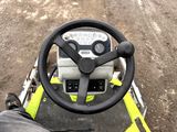 a steering wheel of a yellow and black vehicle