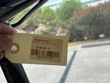 a person holding a bike seat with a price tag attached to it