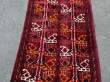 a red and black rug with a pattern on it