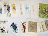 a lot of different colored drawings on a table