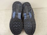 the soles of a pair of black and blue shoes on a white surface