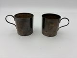 deux tasses marron posées sur une table blanche
