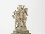 statue of a group of children holding a cross on a pedestal