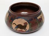 a brown bowl with a picture of a cat on it