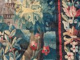 an image of a close up of a tapestry with a castle in the background