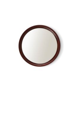 un miroir rond accroché au mur, avec un cadre en bois