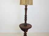 a lamp that is sitting on a table with a lamp shade on it