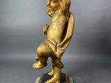antique bronze figurine of a boy on a marble base