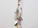 earrings in a clear holder on a white surface