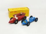 two toy cars sitting next to each other on a table