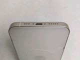 the back of a silver iphone with a small hole in the middle of it
