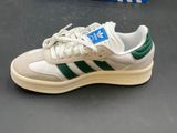 adidas sneakers with green and white stripes on the soles