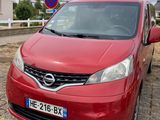 a red car that is parked on the side of the road