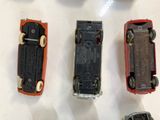 several toy cars are lined up on a white surface