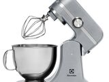 a silver mixer with a metal bowl and a whisk attachment