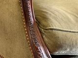 a close up of a chair with a cushion on it