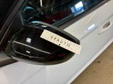 a sticker on the side mirror of a white car