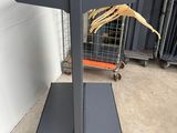a metal rack with clothes hanging on it in a warehouse