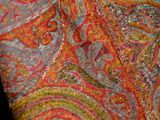 a close up of a paisley tie on a black background