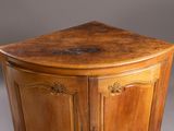 an antique wooden corner cabinet with a marble top