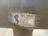 a sign on the side of a metal object