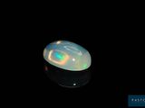 an image of a white oplite in the dark