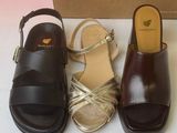 three pairs of women ' s shoes in a box on a table