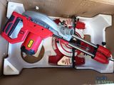 a box with a red drill and some tools inside of it