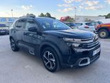 a black suv parked in a parking lot next to other cars