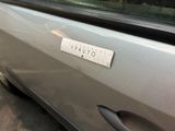 a sticker on the door of a car with a ruler attached to it
