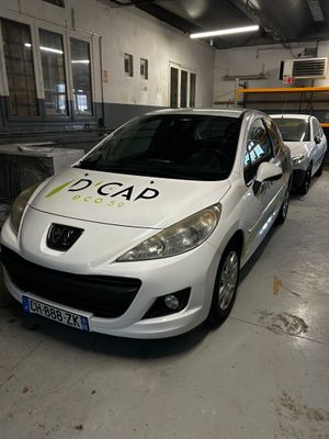 a white car parked in a garage with other cars