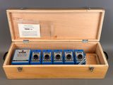 an image of a wooden box with four different types of tape cutters in it