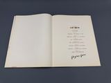 a close up of an open book with writing on it